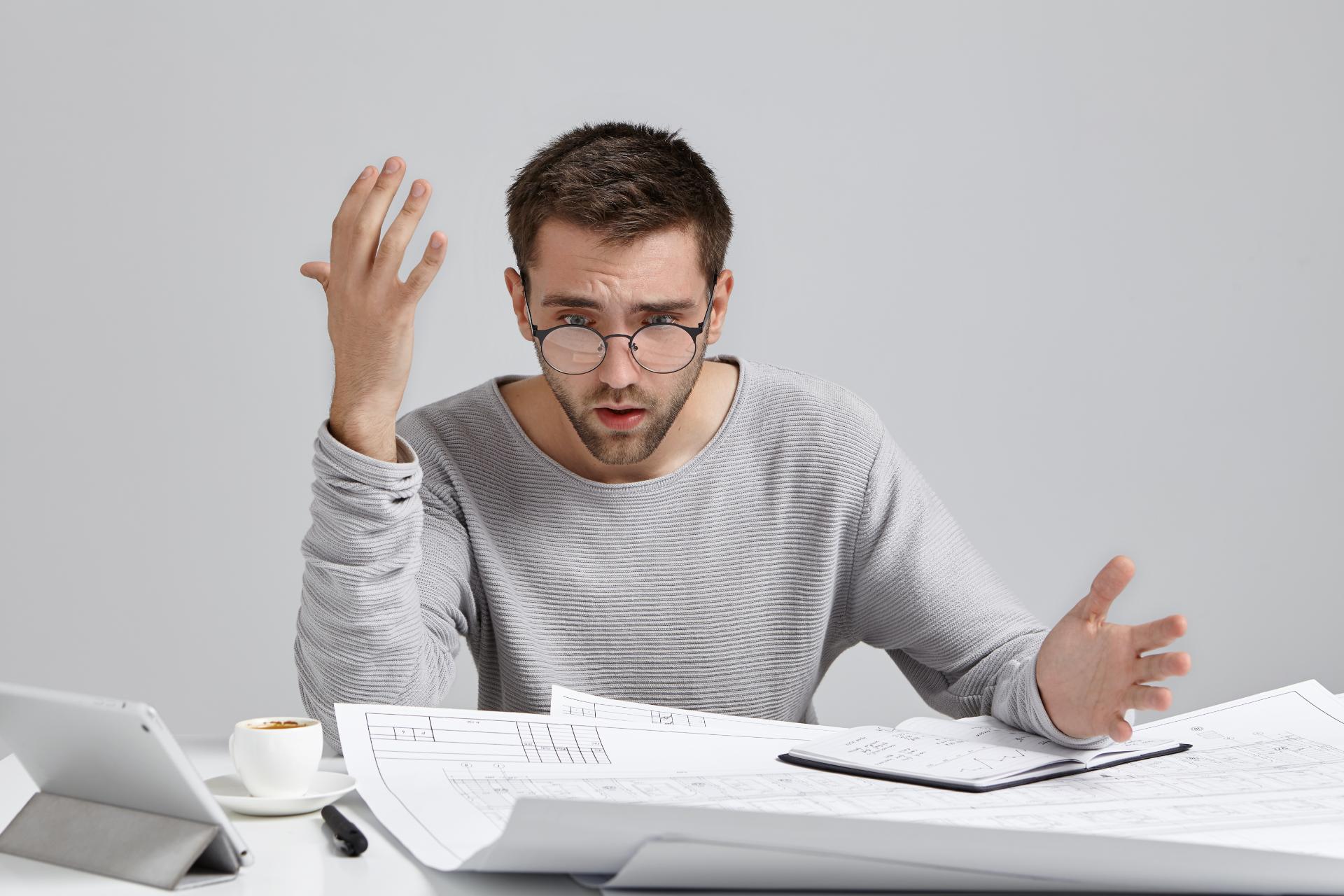 puzzled-and-frustrated-young-architect-in-casual-s-2022-02-03-10-34-28-utc